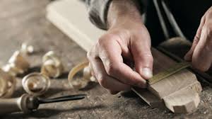 A close-up of hands crafting a product, emphasizing the handmade nature of the goods.